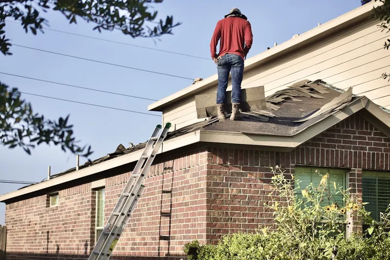 Professional roofer working on a residential roof in Longview
